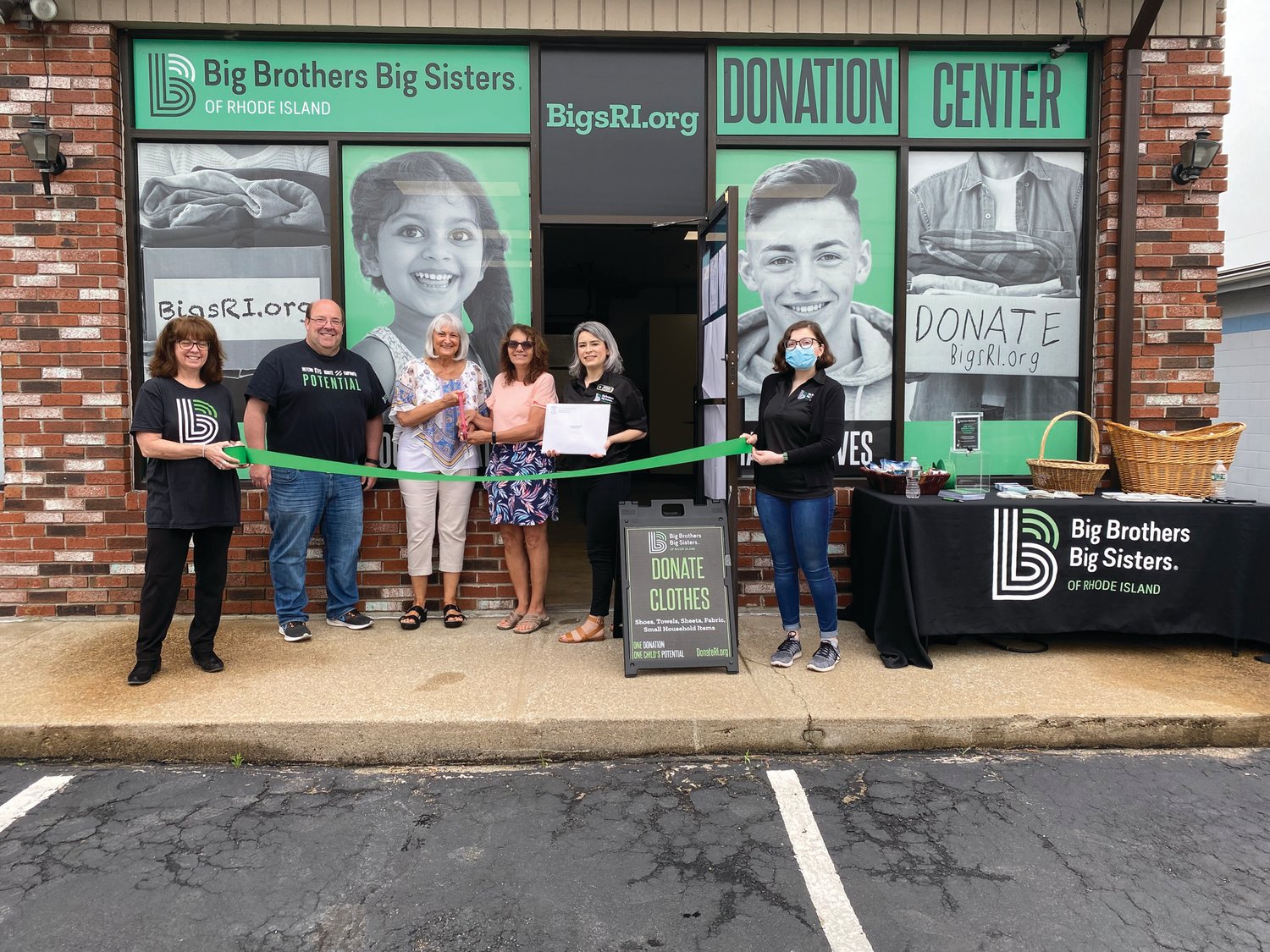 RIBBON SNIPPED: BBBSRI Chief Financial Officer Jack Blatchford, Johnston state Rep. Deborah Fellela, and Johnston Town Councilwoman Lauren Garzone attended the ribbon-cutting for a new donation center at 629 Killingly St. in Johnston.